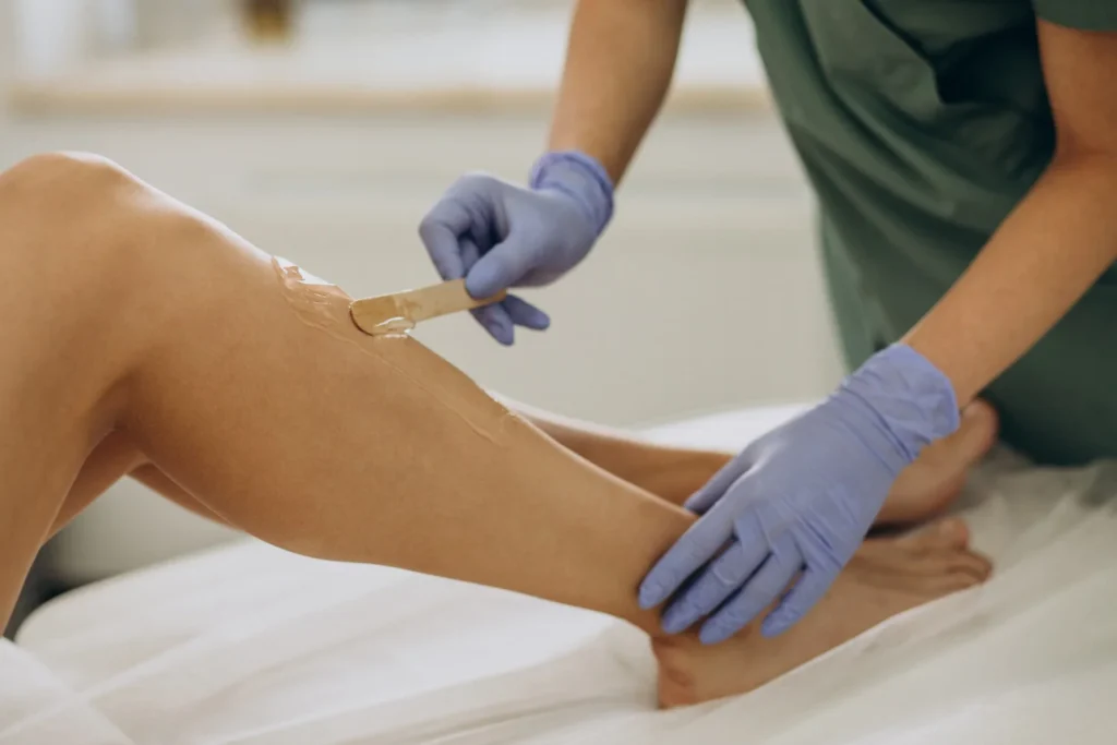 Therapist doing waxing on client