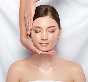 Beautician doing facial massage female customer