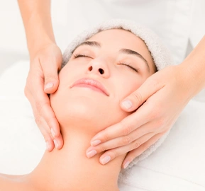 Attractive woman receiving facial massage spa center